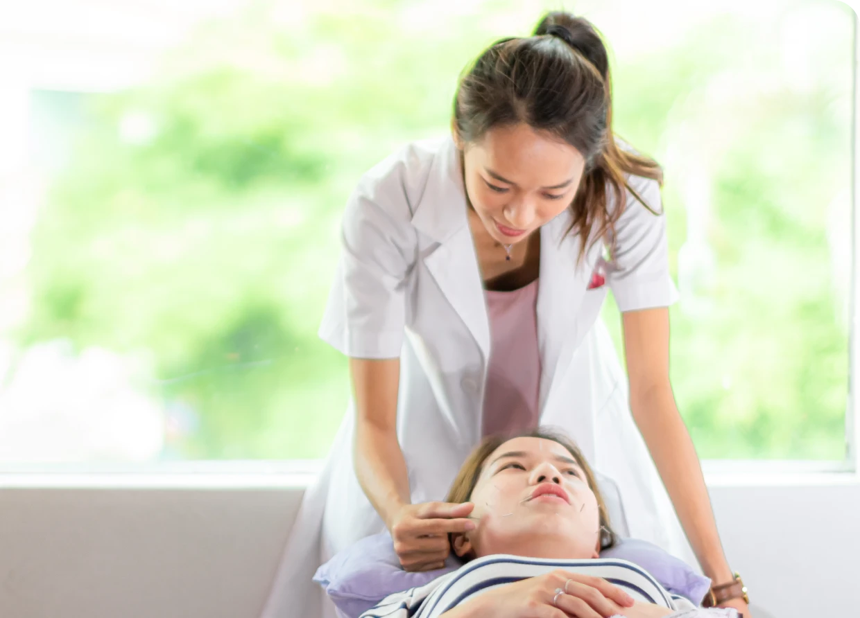 Therapist examining patient in clinic